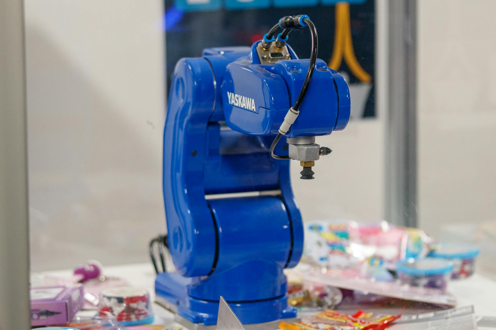 A blue Yaskawa industrial robot arm on display, showcasing advanced technology and robotics.